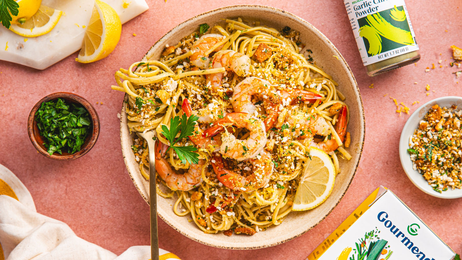Plated bowl of low-FODMAP lemon shrimp linguine garnished with parsley.